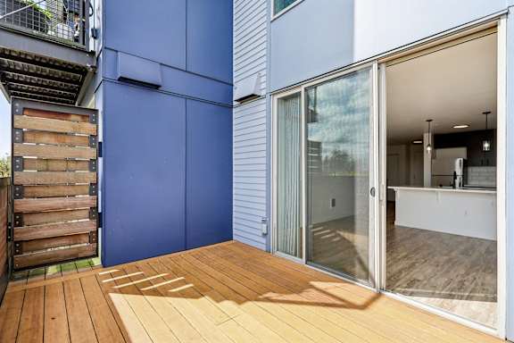 A blue wall with a wooden deck in front.
