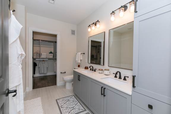 A bathroom with a white towel hanging on a door.