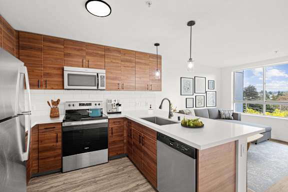 A modern kitchen with wooden cabinets and stainless steel appliances.