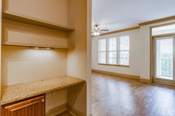 a bedroom with a large window and an empty room