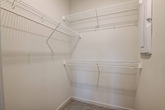 a spacious walk in closet in a bedroom