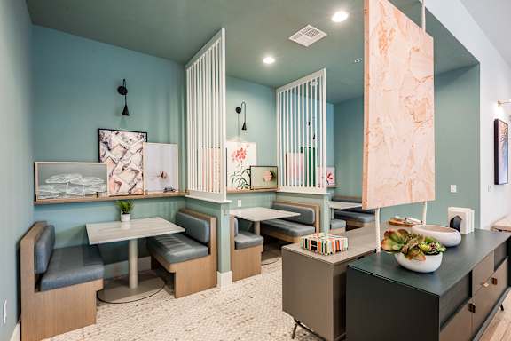 A kitchen with a table and chairs.