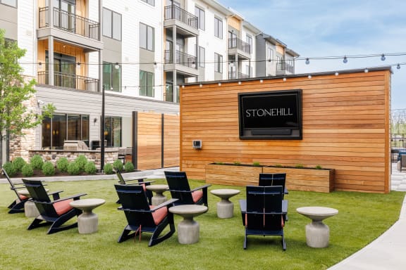a group of tables and chairs in front of a wooden building at Stonehill at West Orange, New Jersey, 07052