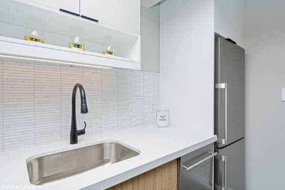 a kitchen with a sink and a refrigerator at Carver and Slowe Apartments, Washington, DC