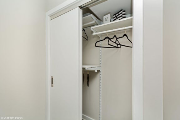 a closet with a white door and a white shelf with glasses on it at Carver and Slowe Apartments, Washington, DC