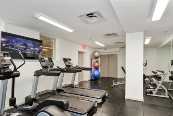 a gym with treadmills and other exercise equipment at Carver and Slowe Apartments, Washington, Washington, DC 20001