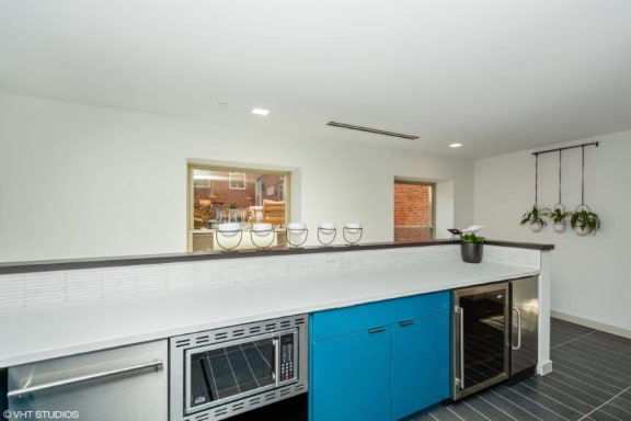 a kitchen with a counter top and a stove top oven at Carver and Slowe Apartments, Washington