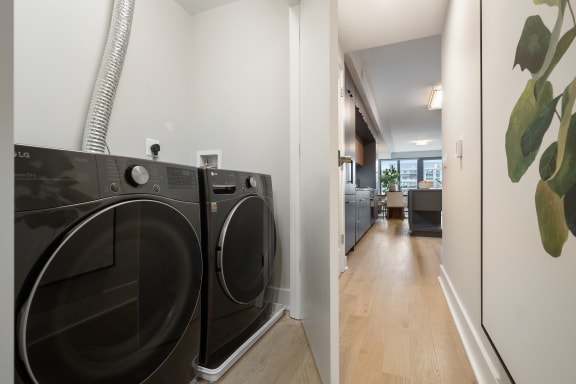 a front load washer and dryer in a laundry room at Tribeca, Washington District of Columbia