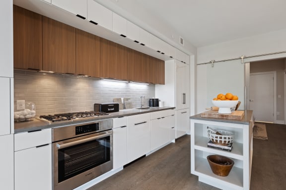 a kitchen with white cabinets and stainless steel appliances at Tribeca, Washington, DC
