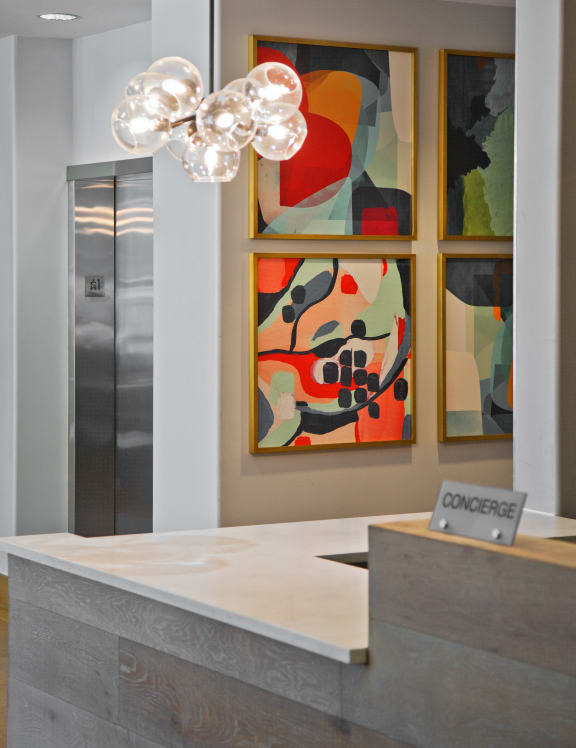 a view of the reception desk with three paintings on the wall at 3333 Wisconsin, Washington, DC