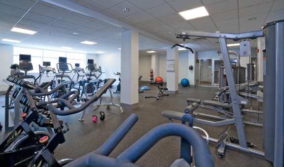 a room filled with cardio equipment and weights at 3333 Wisconsin, Washington, 20016