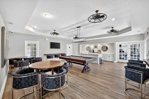 A modern dining room with a wooden table and blue chairs.