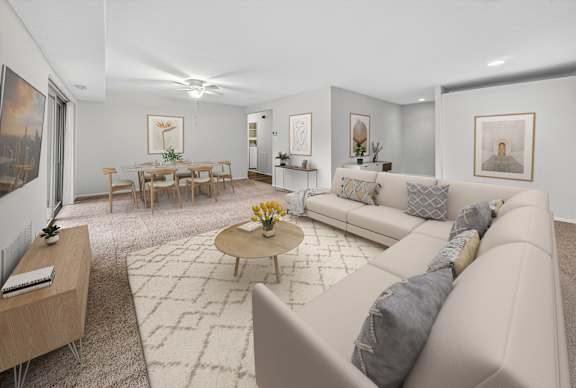 A living room with a couch, coffee table, and chairs.