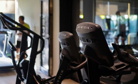 a row of exercise bikes in a gym