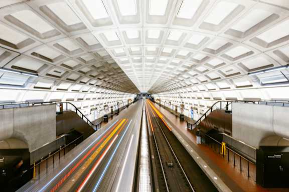 A train station with a train on the tracks.