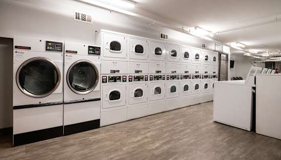 A row of washing machines in a laundromat.