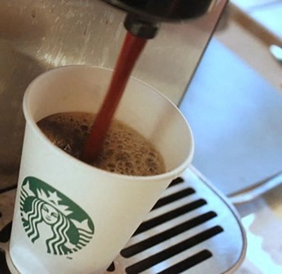 a cup of coffee being poured into a starbucks cup at The Chesapeake, DC