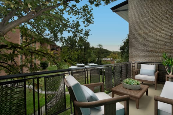 a porch with chairs and a table on a balcony