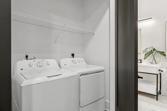 A white washing machine and dryer in a laundry room.
