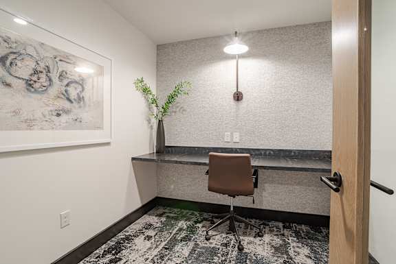 Private workspace with floating desk and modern chair at The Yancey Apartments, North Carolina