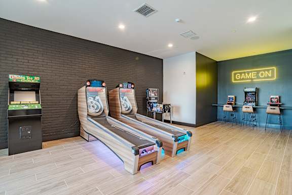 Game room with arcade machines and skeeball lanes at The Yancey Apartments, Charlotte, NC 28217