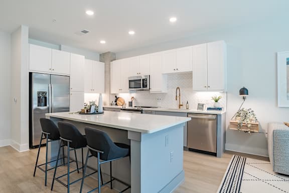 Open kitchen with center island and bar stools at The Yancey Apartments, Charlotte