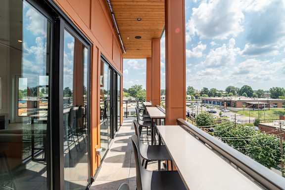 Covered terrace with counter seating and urban views at The Yancey Apartments, Charlotte, NC