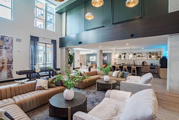 Double height clubhouse lounge with modern furnishings at The Yancey Apartments, Charlotte, North Carolina