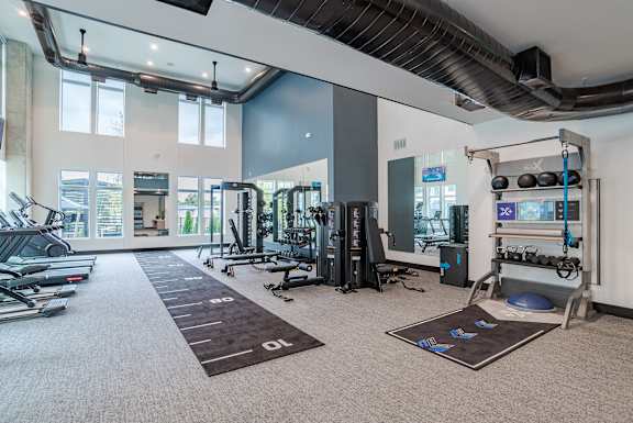Fitness center with strength training equipment and functional zone at The Yancey Apartments, Charlotte, NC