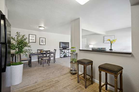 A kitchen with a table and chairs.