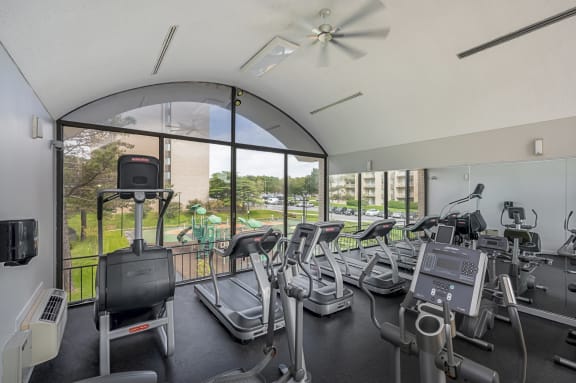 fitness center with cardio machines at Seven Springs Apartments, Maryland 20740