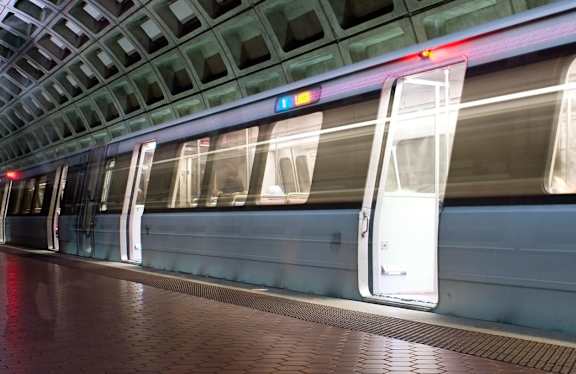 A subway train is stopped at a station.