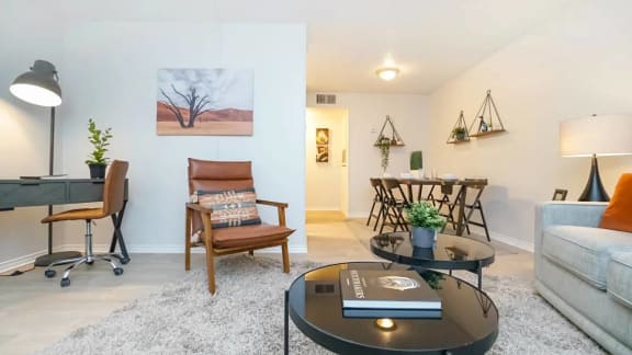 a living room with a couch and a table at Elevate at Huebner Grove, San Antonio, TX 78230
