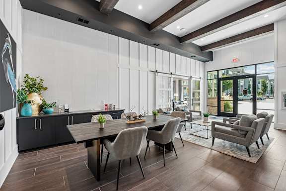 A modern dining room with a wooden table and grey chairs.