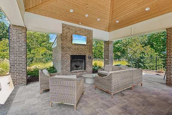 A patio with a fireplace and seating area.