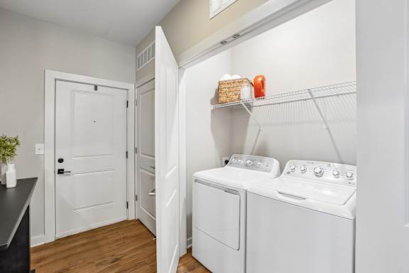 A small laundry room with a washer and dryer.