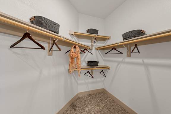 A room with three shelves and a carpeted floor.