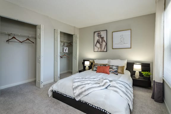 a bedroom with a large bed and a closet at The Carter 4250 Apartments, Norcross