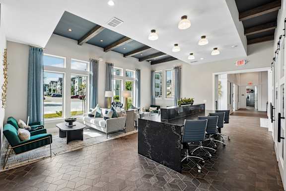 A spacious office lobby with a reception desk and chairs.