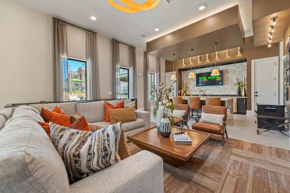 A living room with a grey couch and a wooden coffee table.