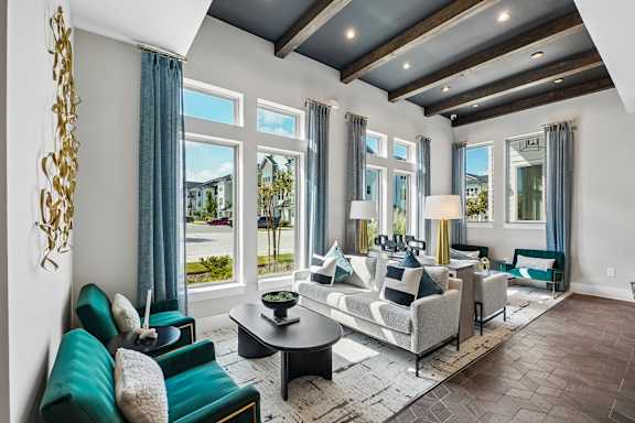 A living room with a large window and a view of the street.