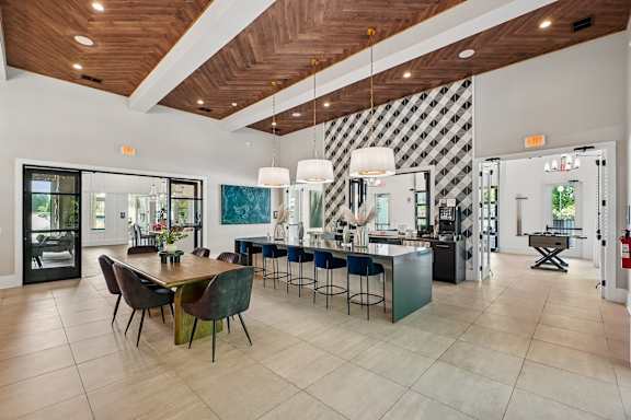 A modern kitchen with a dining table and chairs.