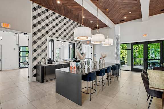 A kitchen with a black and white checkered wallpaper.