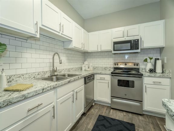 a renovated kitchen with stainless steel appliances  at Avenues of Kennesaw East & West, Kennesaw