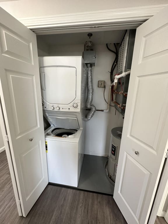 a small laundry room with a washer and dryer at Carisbrooke at Manchester Apartments, Manchester, New Hampshire
