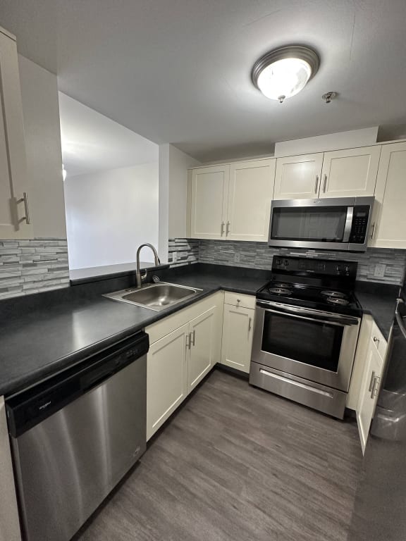 an overhead view of a kitchen with a refrigerator and microwave at Carisbrooke at Manchester Apartments, New Hampshire, 03102