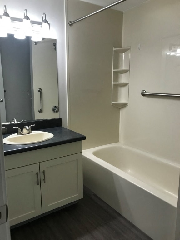 a bathroom with a sink and a bath tub at Carisbrooke at Manchester Apartments, Manchester, NH
