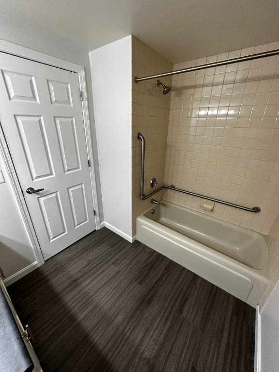 a bathroom with a shower and a bath tub at Carisbrooke at Manchester Apartments, New Hampshire