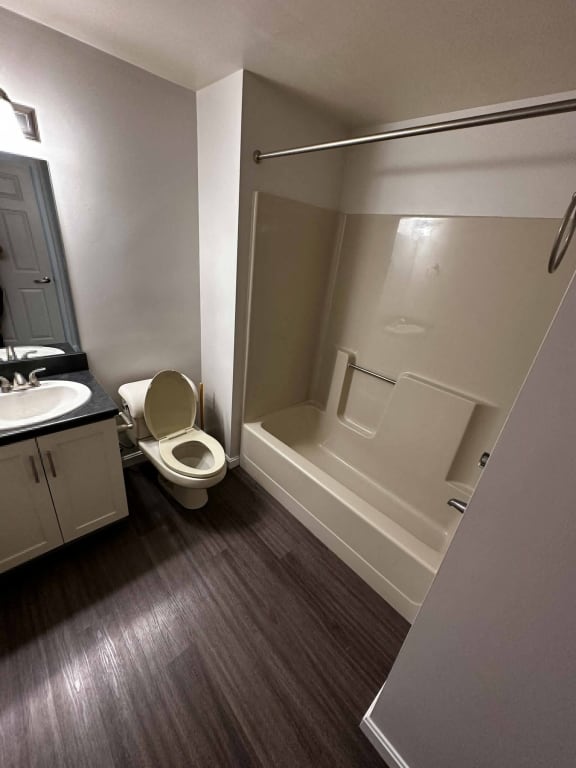 a bathroom with a toilet and a sink and a bath tub at Carisbrooke at Manchester Apartments, New Hampshire, 03102