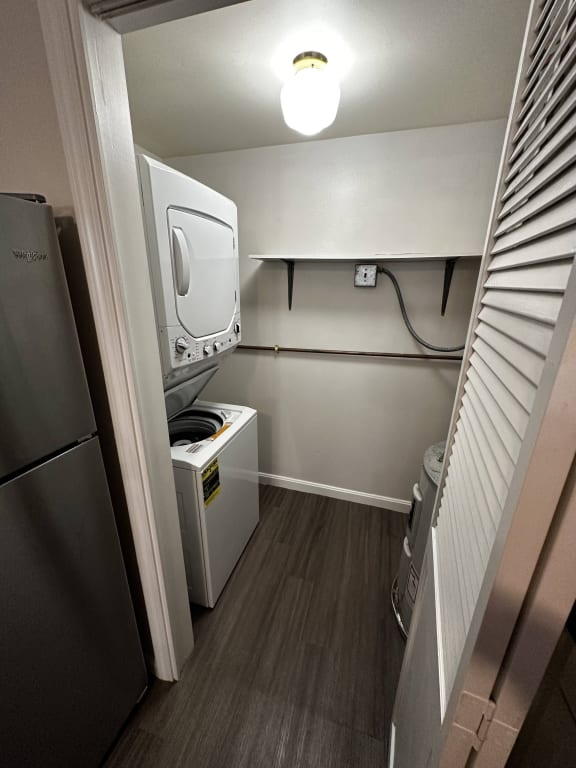 a small room with a refrigerator and a microwave at Carisbrooke at Manchester Apartments, New Hampshire, 03102